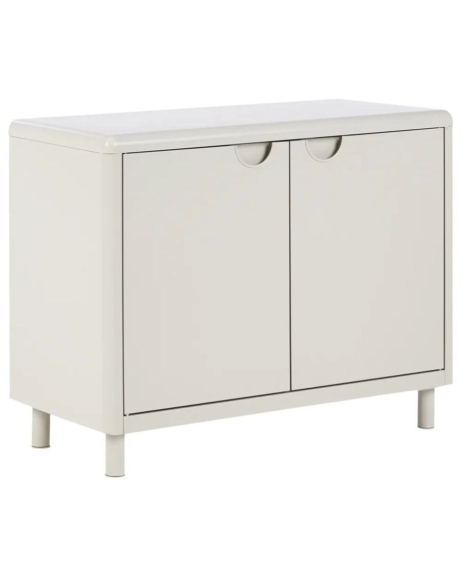 A modern two-door storage cabinet in a warm off-white finish, featuring minimalist circular pull handles and short legs, shown against a plain white background.