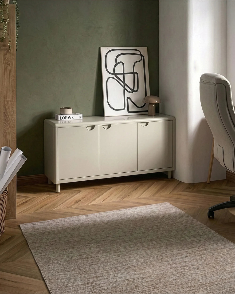 Beige sideboard with abstract art in a room with a rug and chair.