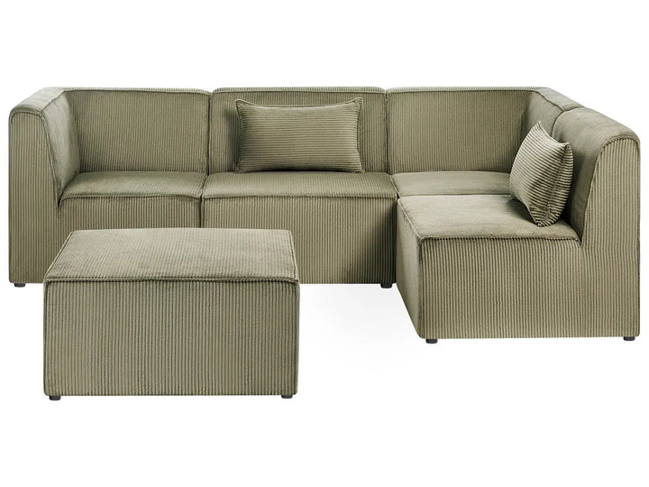 An L-shaped sectional sofa upholstered in a textured corduroy fabric in a muted sage green color, accompanied by a matching rectangular ottoman and two decorative throw pillows, shown against a plain white background.
