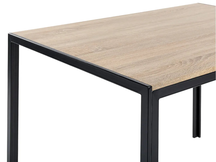 Close-up of a rectangular table showing a light oak wood grain top and a black metal frame leg, isolated on a white background.