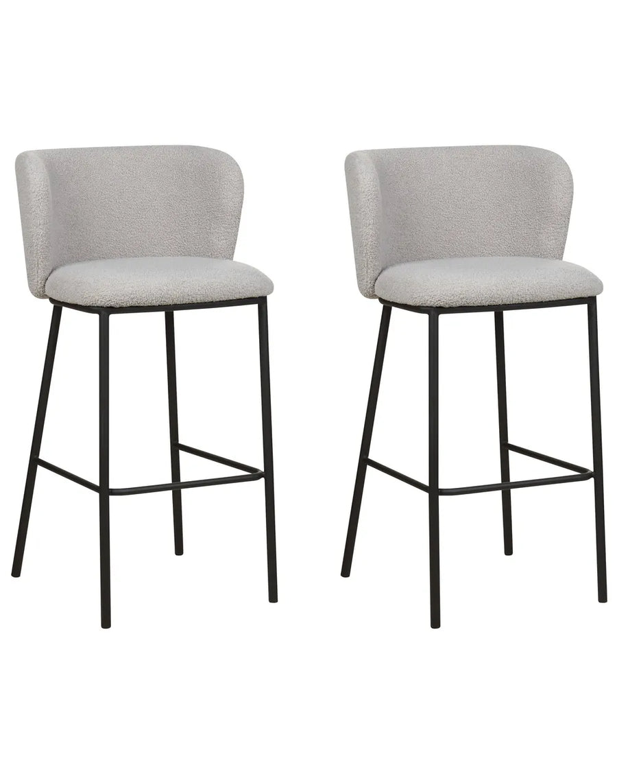 Two modern bar stools with light gray textured fabric seats and curved backs, supported by slim black metal legs, shown against a plain white background.