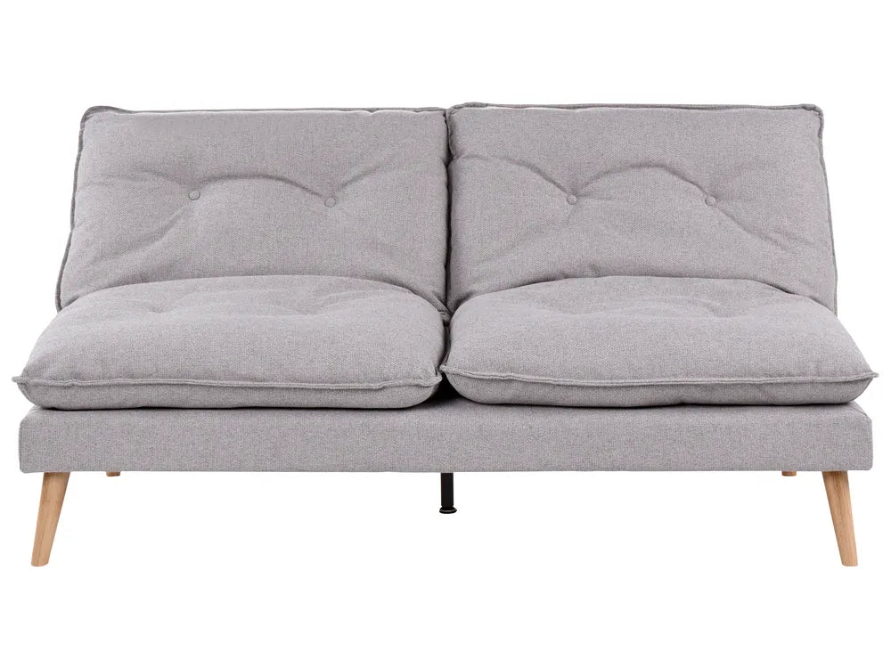 A light gray fabric futon sofa with two tufted back cushions, two thick seat cushions, and tapered light wood legs, shown against a plain white background.