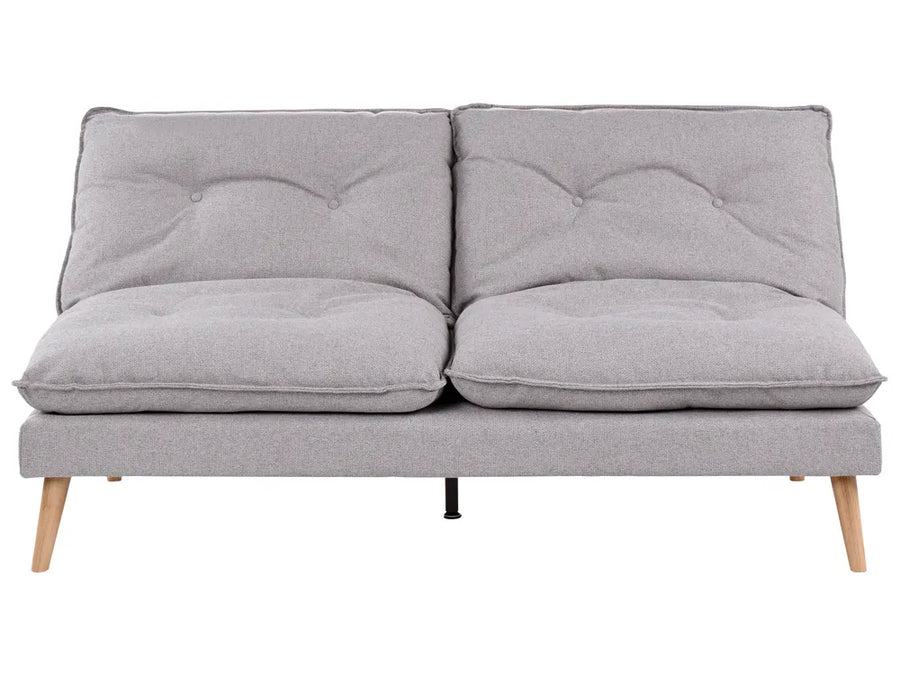 A light gray fabric futon sofa with two tufted back cushions, two thick seat cushions, and tapered light wood legs, shown against a plain white background.