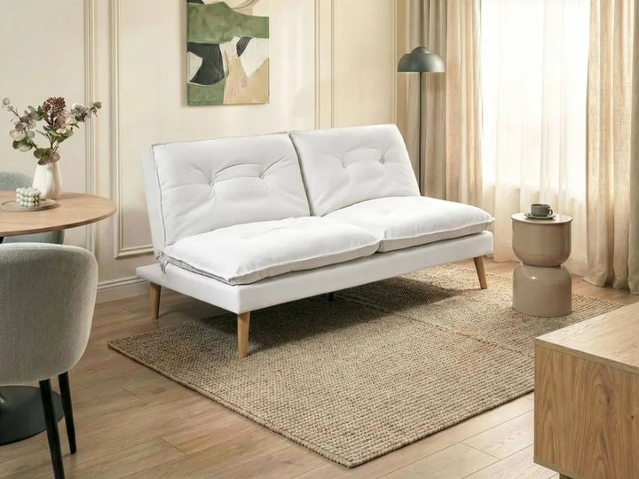 White sofa in a living room with wooden floor and decor