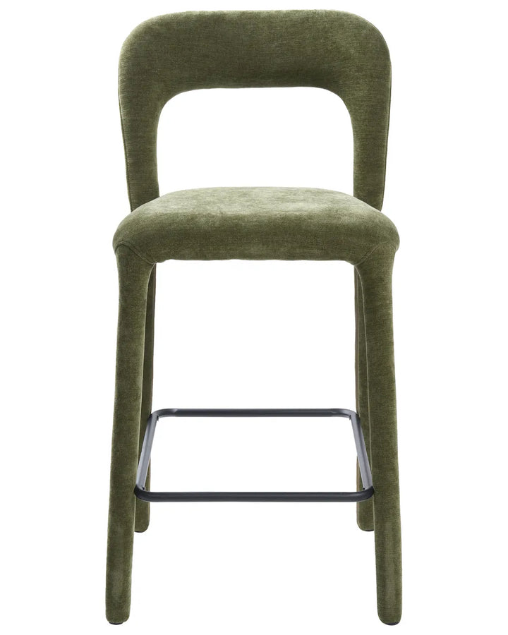 An upholstered bar stool with a curved backrest and seat in textured olive green fabric, supported by slim legs with a black metal footrest bar, shown against a plain white background.