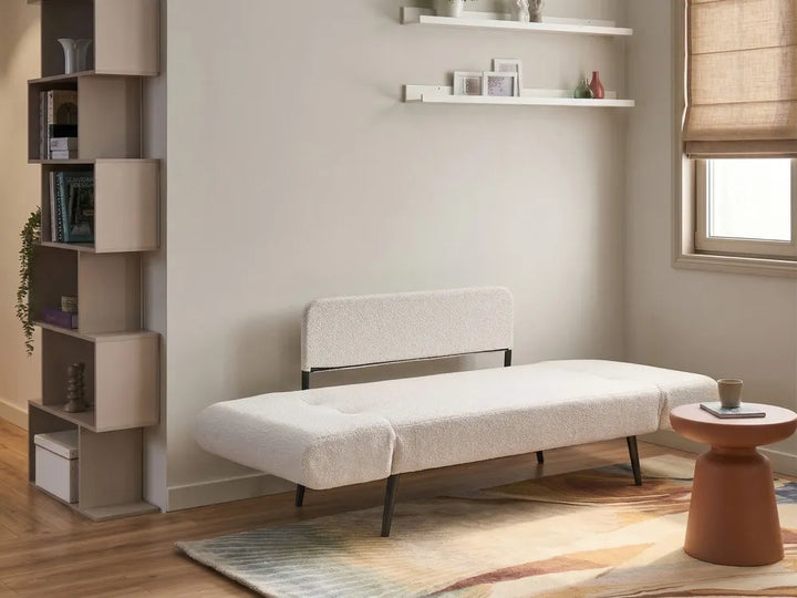 A modern two-seater sofa upholstered in a textured cream bouclé fabric.