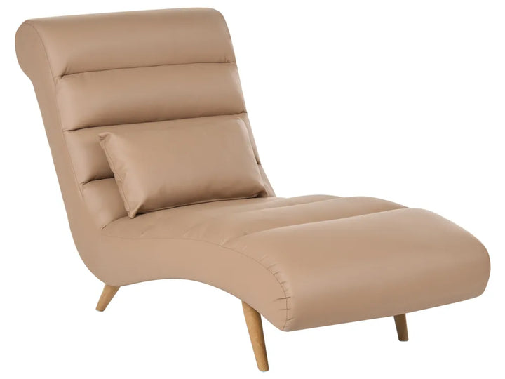 A modern chaise lounge chair upholstered in a warm beige faux leather or leather-like material, featuring a matching lumbar pillow and light wood legs, shown against a plain white background.