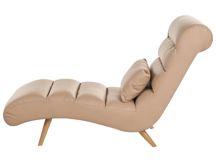 A modern chaise lounge chair upholstered in light beige faux leather with a matching lumbar pillow and light wood legs, shown against a plain white background.