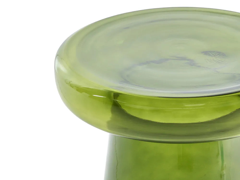 Close-up of a translucent light green glass stool or pedestal with a thick circular top and smooth curved base, photographed against a white background.