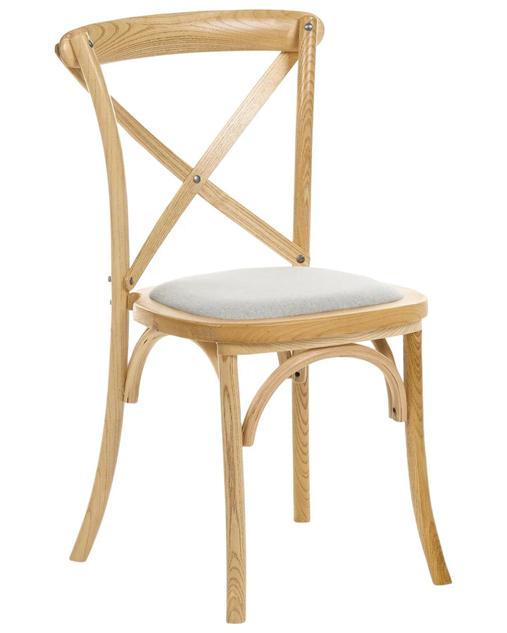 A light natural wood dining chair with a curved backrest, crossed X-back supports, and a light gray upholstered seat cushion, shown against a plain white background.
