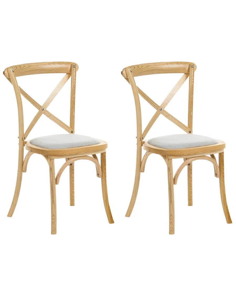 Two light natural wood dining chairs with curved legs and light gray upholstered seats, shown on a plain white background.