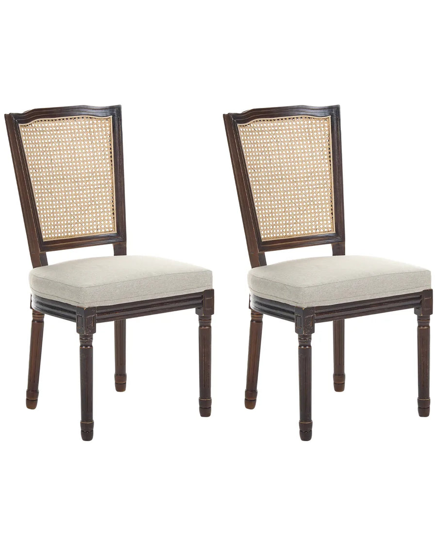 Two matching wooden dining chairs with woven cane backrests and light beige upholstered seats, shown on a plain white background.