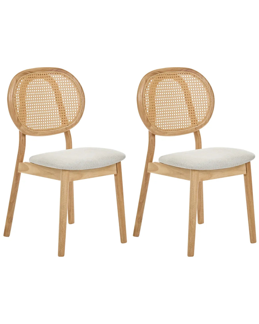 Two light oak dining chairs with woven cane backrests and light beige upholstered seats, shown on a plain white background.