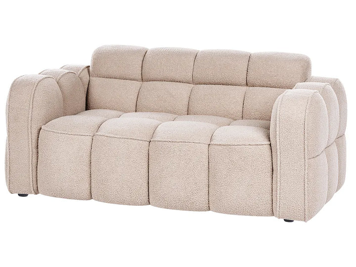 A modern tufted loveseat sofa upholstered in a textured beige bouclé fabric, shown from a three-quarter angle against a plain white background.