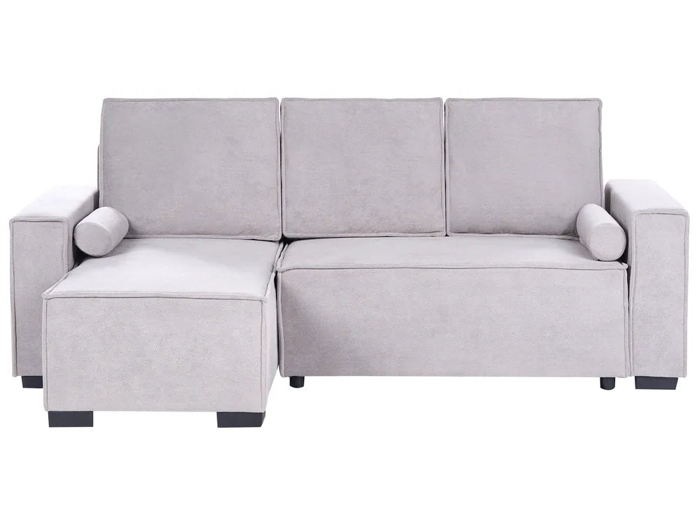 A light gray upholstered sectional sofa with a left-facing chaise lounge, three back cushions, cylindrical armrests, and small dark feet, shown on a plain white background.