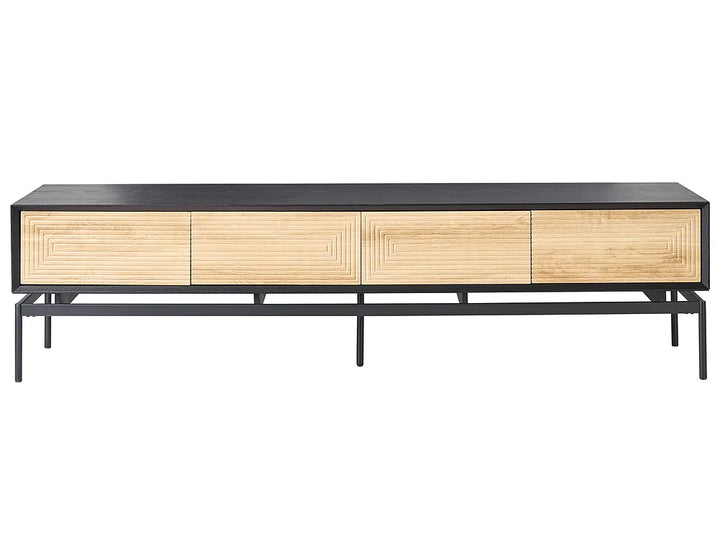 A modern media console with a black metal frame and top, featuring four light natural wood drawers with geometric reeded panel designs, set against a plain white background.
