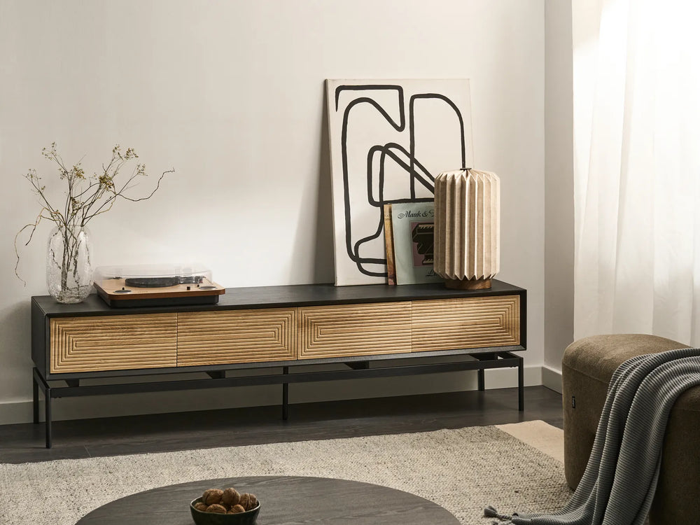 Modern living room with a wooden TV stand, abstract art, and decorative items.