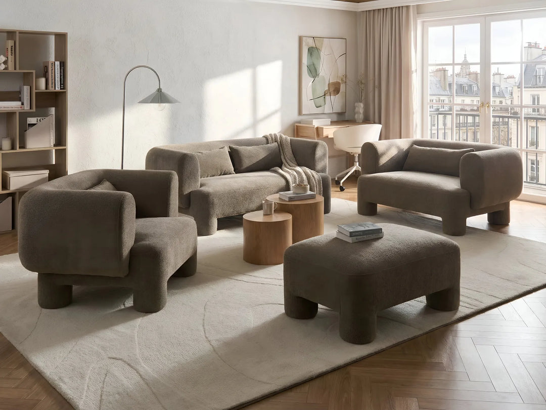 Modern living room with brown furniture and large windows.