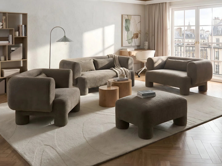 Modern living room with brown furniture and large windows.
