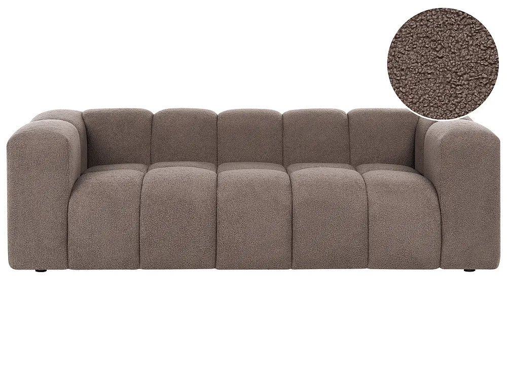 A modern low-profile sofa with a tufted, segmented backrest and chunky armrests in a textured taupe fabric, featuring a circular fabric close-up inset in the top right corner.