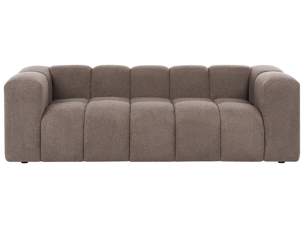 A modern low-profile sofa upholstered in a textured taupe fabric, featuring a segmented, tufted backrest and chunky armrests, shown against a plain white background.