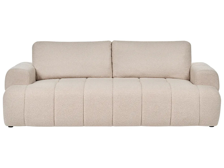 A modern beige bouclé three-seater sofa 