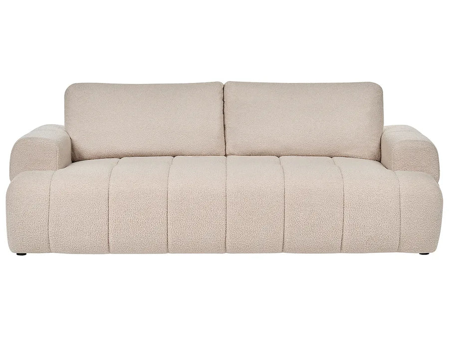 A modern beige bouclé three-seater sofa 