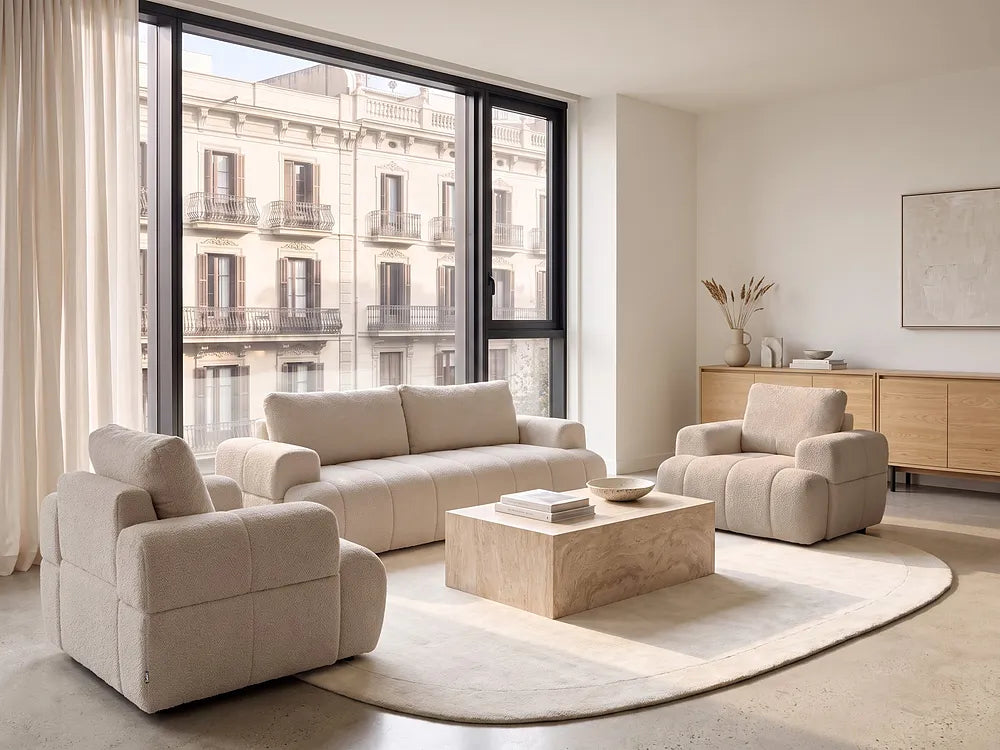 A modern beige bouclé three-seater sofa.