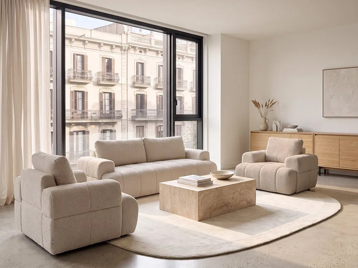 A modern beige bouclé three-seater sofa.