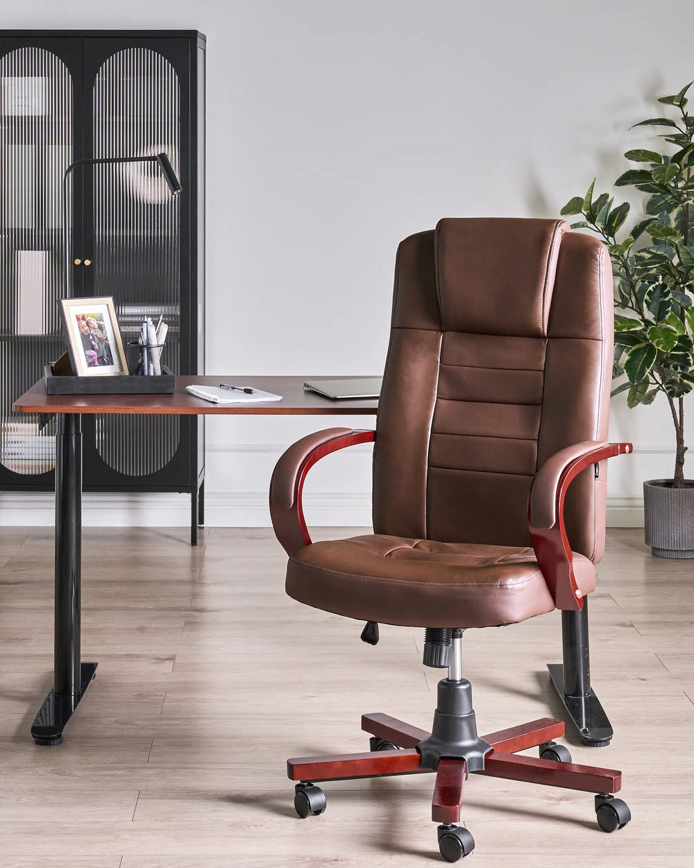 Brown office chair in a home office setting with a desk and decor.
