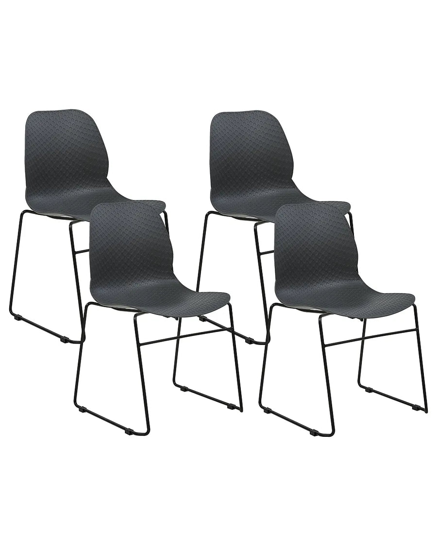 Four black molded plastic dining chairs with slim metal legs, arranged in two pairs against a plain white background.