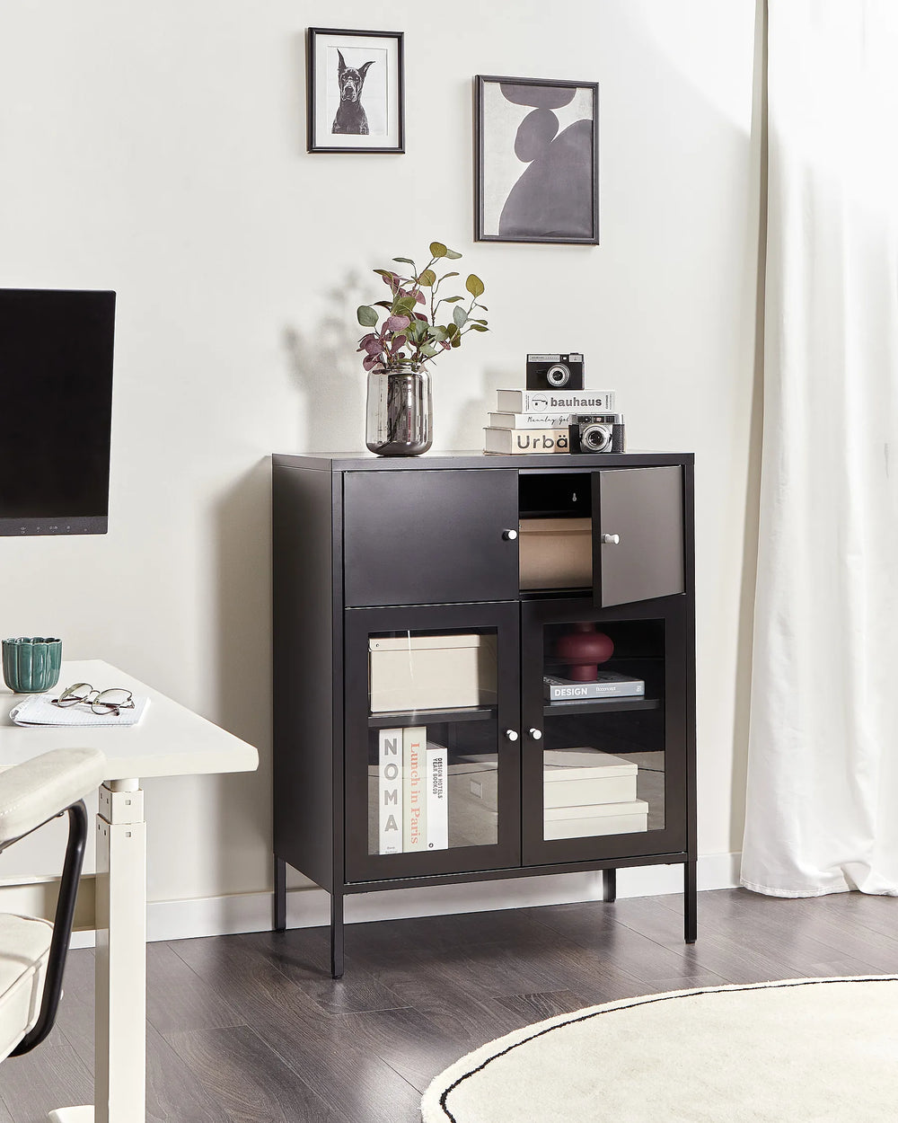 Dark wooden cabinet with glass doors in a room with a TV and decor items.