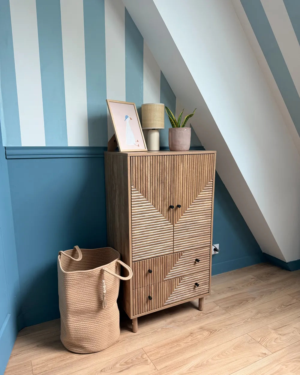 A mid-century modern wooden cabinet with a distinctive slatted geometric pattern