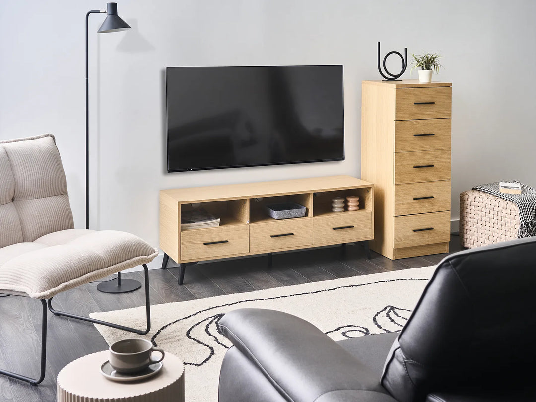 Modern living room with a TV stand, sofa, and armchair.