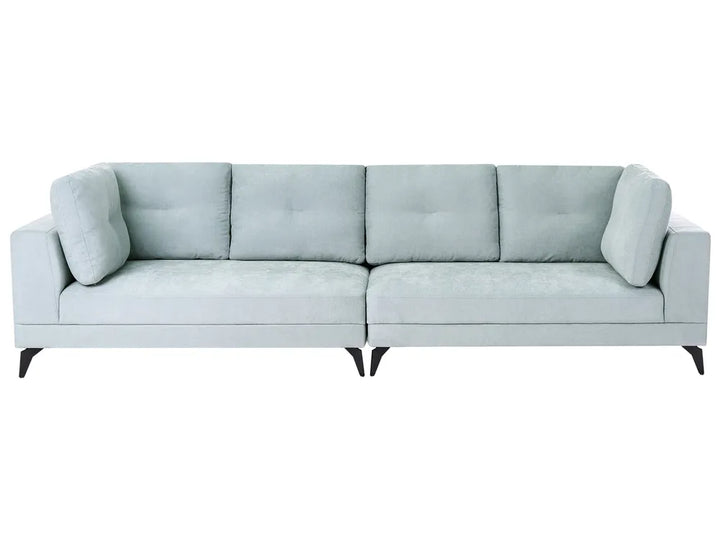 A modern three-seater sofa upholstered in a light sage green fabric, featuring tufted back cushions, square arms, and slim black legs, shown against a plain white background.