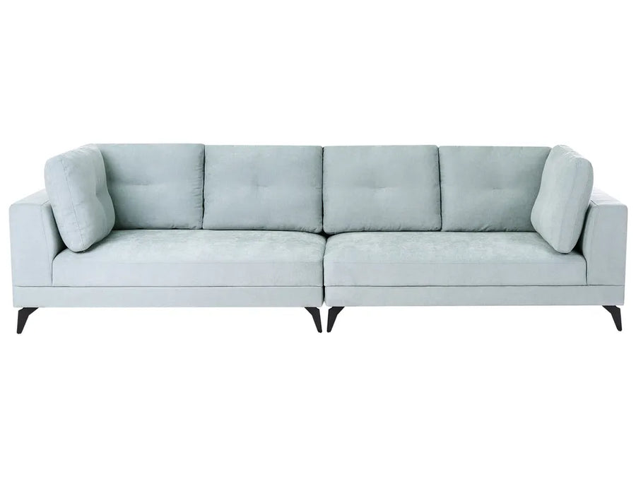 A modern three-seater sofa upholstered in a light sage green fabric, featuring tufted back cushions, square arms, and slim black legs, shown against a plain white background.