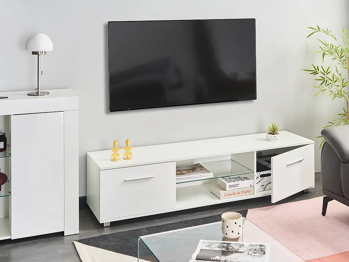 A modern white TV console with open shelving and side cabinets, styled in a living room setting below a wall-mounted flat-screen television.