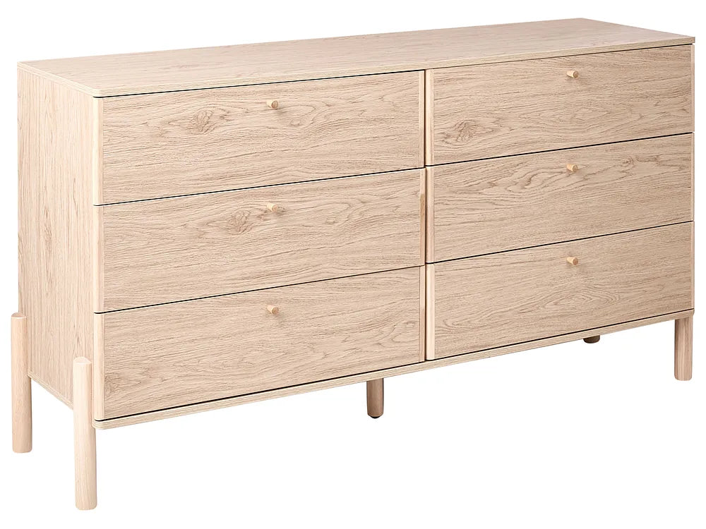 Wooden dresser with four drawers on a white background