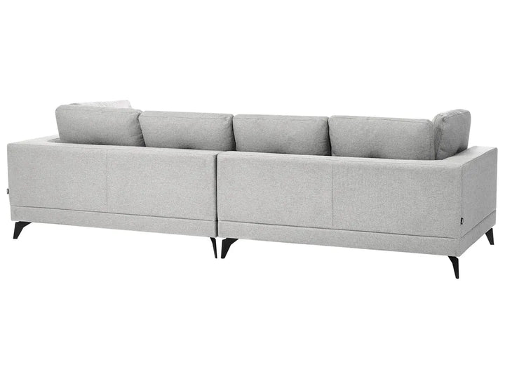 A light gray fabric sectional sofa with a low back and tapered black legs, shown from a three-quarters angle against a plain white background.