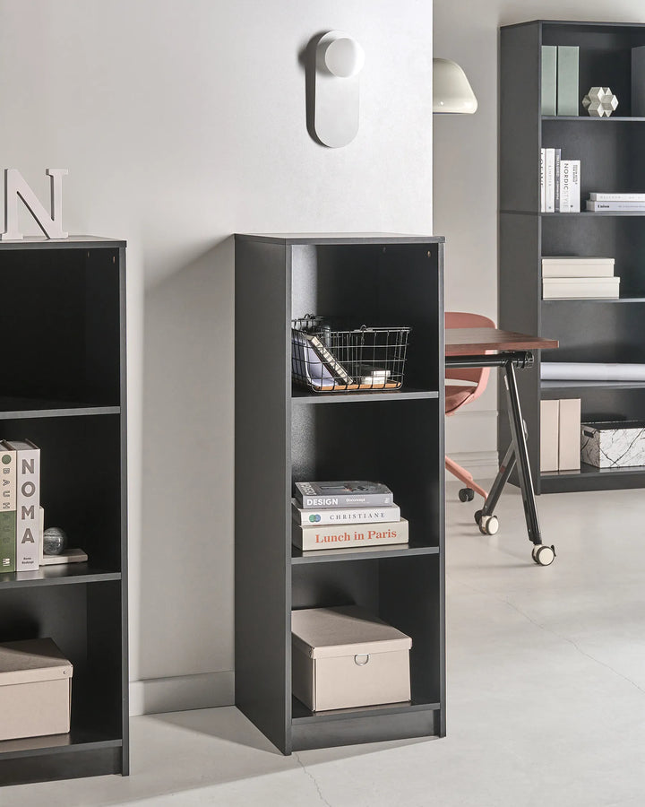 Black bookshelf with books and decorative items in a room setting