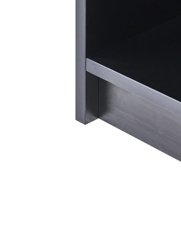 Close-up detail of a dark gray metal shelving unit corner with a black shelf surface, shown on a plain white background.