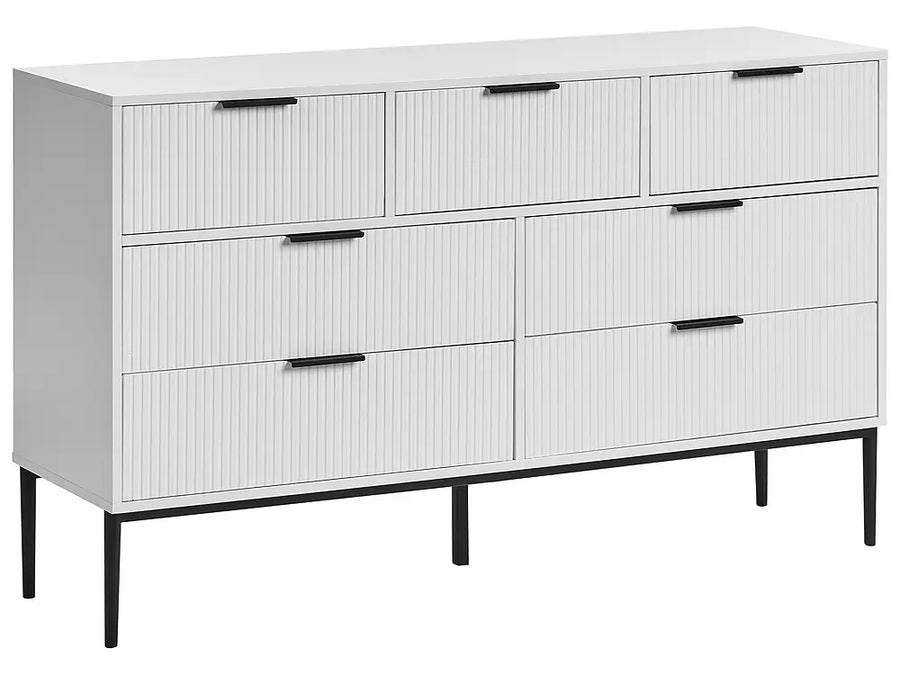A modern six-drawer dresser in white with vertical ribbed drawer fronts, black metal handles, and slim black legs, shown on a plain white background.