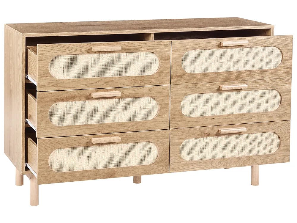 A light oak wood chest of drawers with six drawers, featuring oval woven cane inserts and light wood handles, shown on a white background.