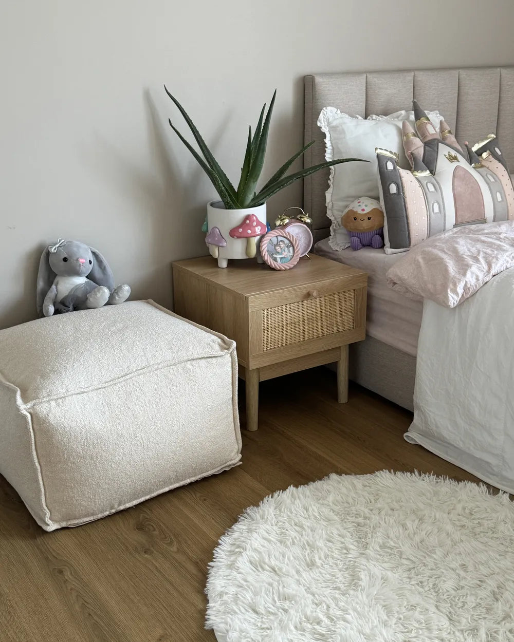 A light oak wood side table with a single drawer