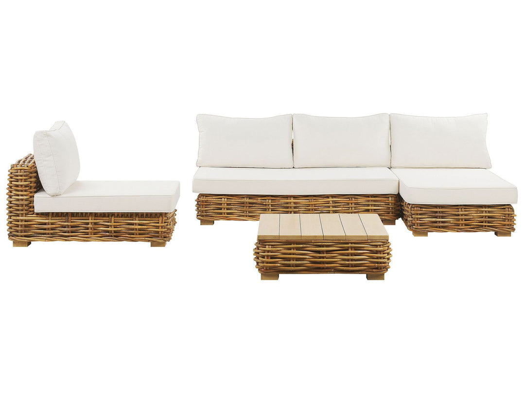 A garden lounge set comprising of a sofa, armchair, garden lounger, and a square table made of rattan with natural finish and white cushions.