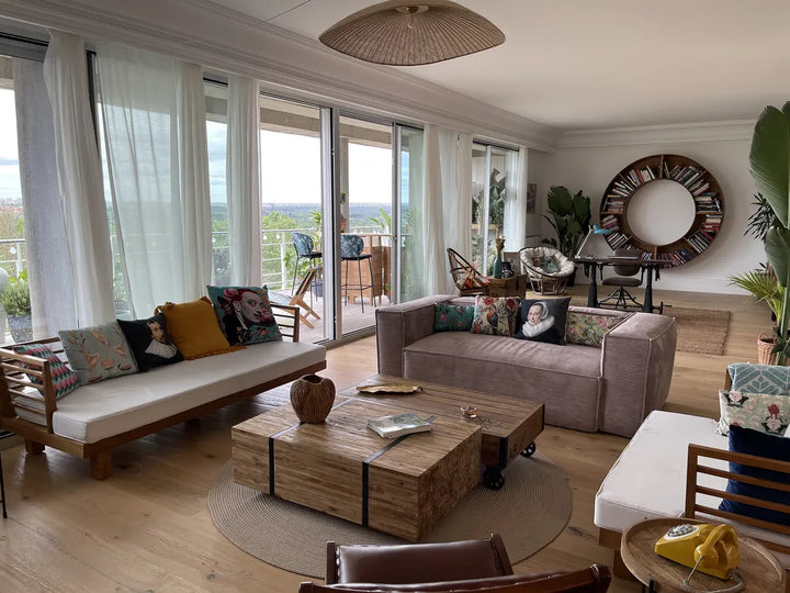 Modern living room with a sofa, coffee table, and decorative items.
