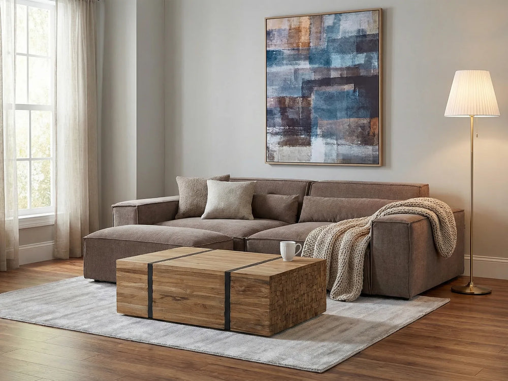 Modern living room with a sectional sofa, wooden coffee table, and abstract art on the wall.