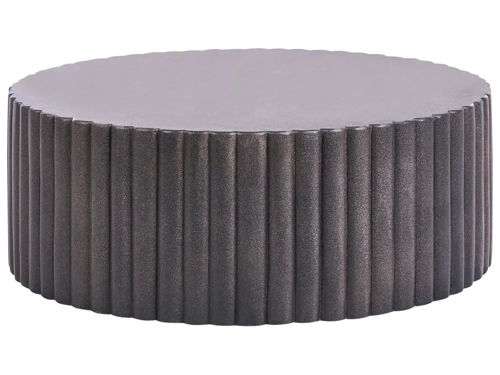 Round ottoman with textured surface and gray cushion on a white background