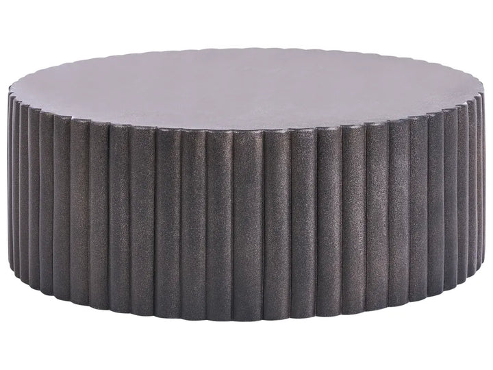 Round ottoman with textured surface and gray cushion on a white background