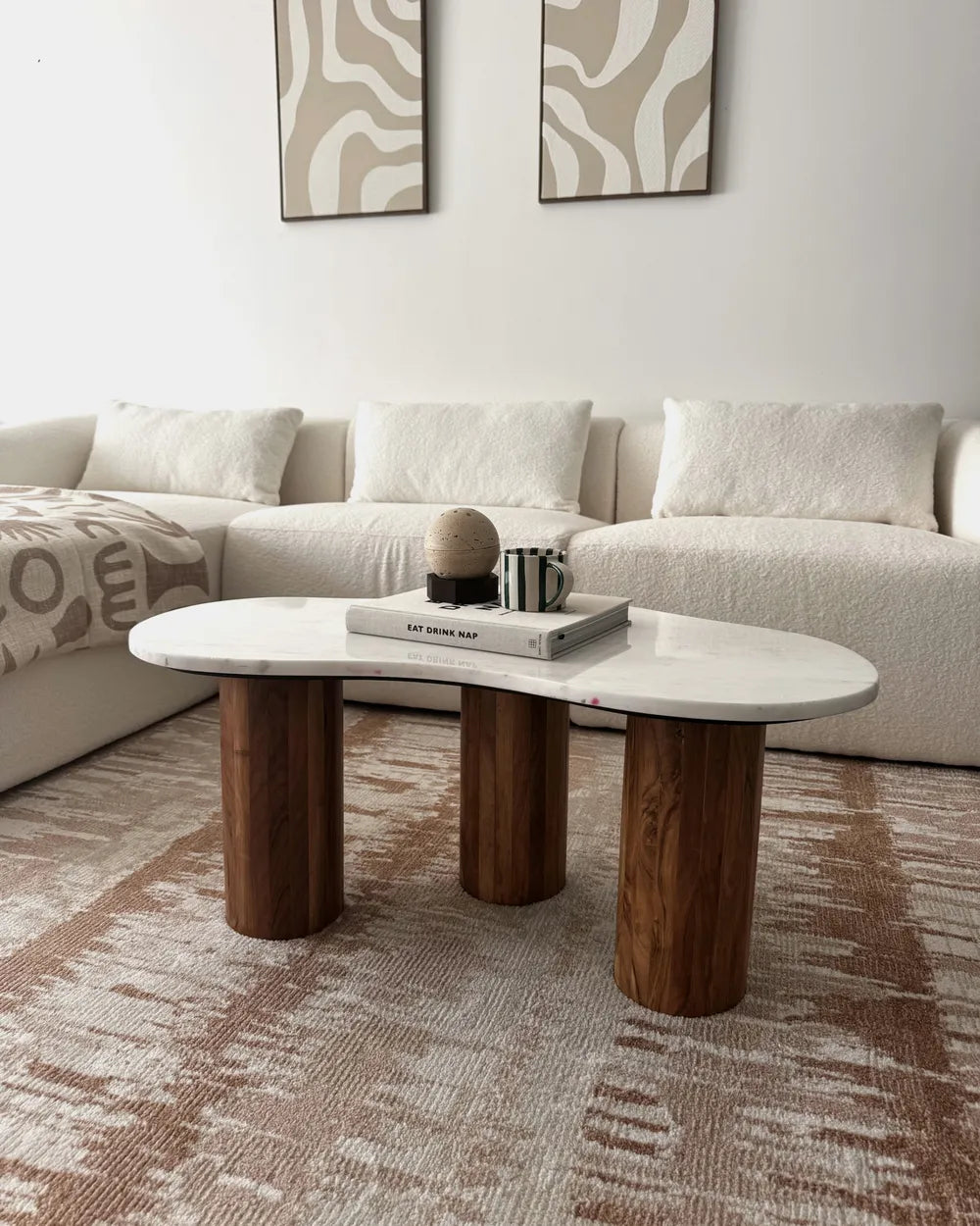 Modern living room with a white sofa and wooden coffee table.